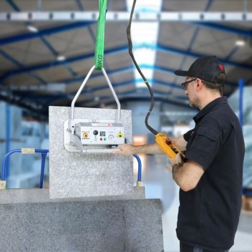 Worker using Aardwolf Swiftlift ASVL380 handle a vertical stone workpiece