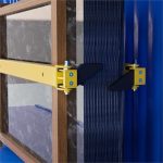 Close-up of ABACO Container Bundle Slab Loader M2 securing a bundled stack of stone slabs