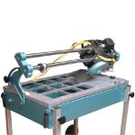 Angled view ABACO Stone Saw with sliding cutting head, working table, blade guard, and support frame