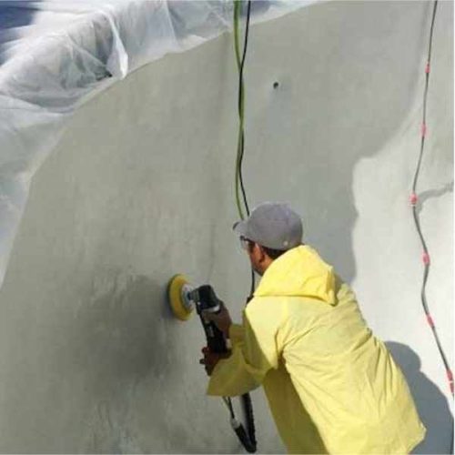 Worker using ALPHA AIR-680UW pneumatic polisher on a swimming pool wall