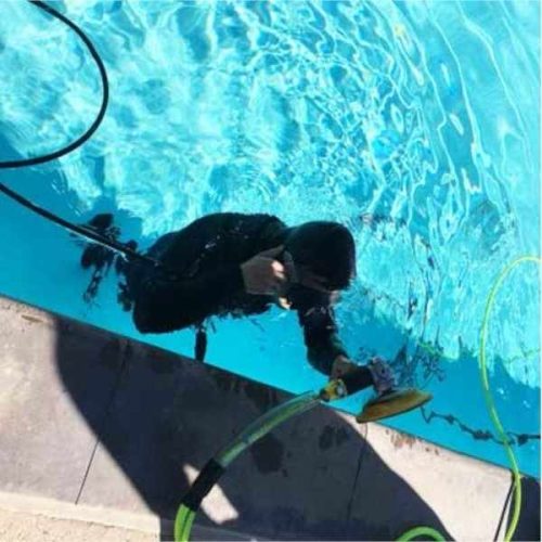 ALPHA AIR-680UW pneumatic polisher operating underwater on a swimming pool surface