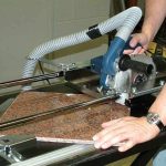 Worker using Alpha Dry Porcelain Paver Tile Cutting System on a tile panel
