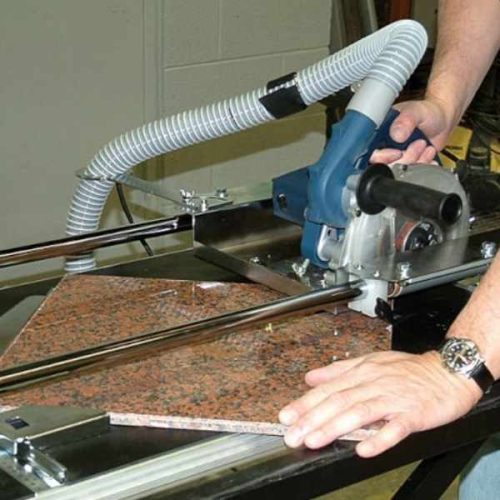 Worker using Alpha Dry Porcelain Paver Tile Cutting System on a tile panel