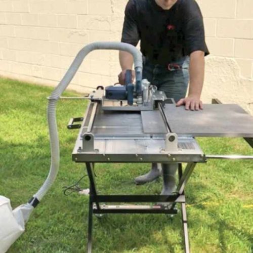 Worker operating Alpha Dry Porcelain Paver Tile Cutting System on an outdoor worksite