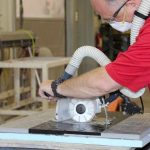 Worker operating Alpha ECC-125 Ecocutter on a stone slab