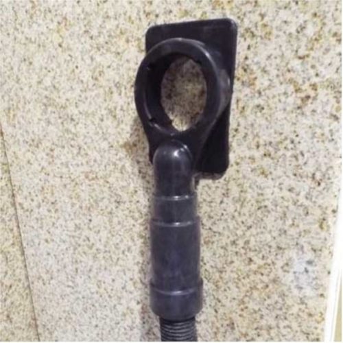 Alpha Ecoguard CD attached vertically to a stone wall with vacuum hose connected