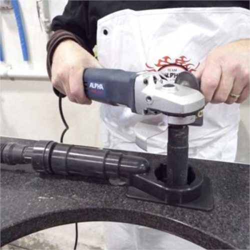 Worker drilling a countertop with Alpha Ecoguard CD connected to a vacuum hose