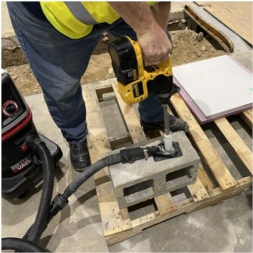 Worker using Alpha Ecoguard CD while drilling into a concrete block