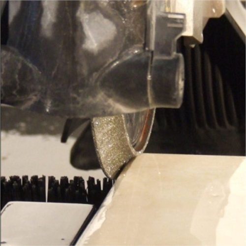 Close-up Alpha Marble Profile Wheel contacting a marble tile edge