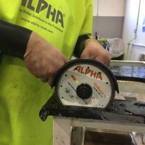 Close-up showing ALPHA PSC-600 Pneumatic Stone Cutter blade cutting a stone edge