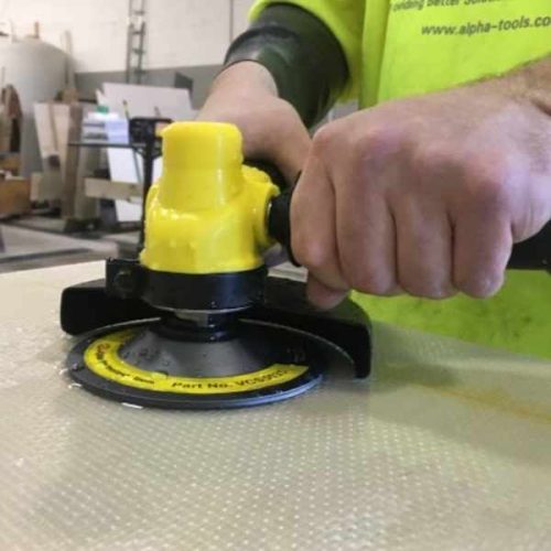 ALPHA PSC-600 Pneumatic Stone Cutter operating with a grinding disc on stone