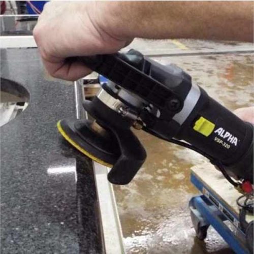 Worker using Alpha VSP-320 Variable Speed Polisher on a wet stone edge