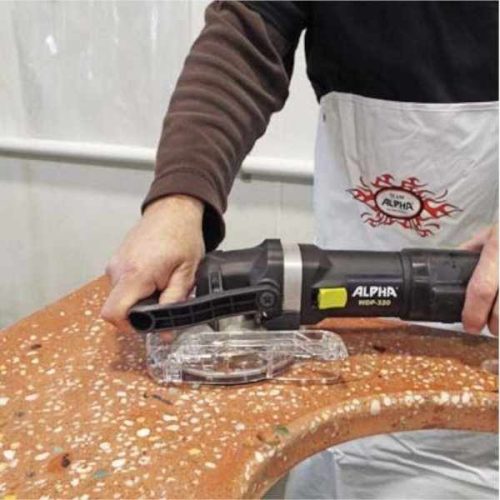 Worker using Alpha WDP-320 Wet/Dry Variable Speed Polisher along a stone edge