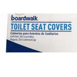 Close-up showing Boardwalk Premium Half-Fold Toilet Seat Covers and folded white paper surface