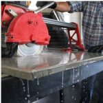 Worker using DiStar Hard Ceramics Advanced 4.5″ diamond blade to cut porcelain tile