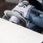 Worker using DiStar Hard Ceramics DGM 2″ Grinding Wheel 60/70 on a ceramic tile edge