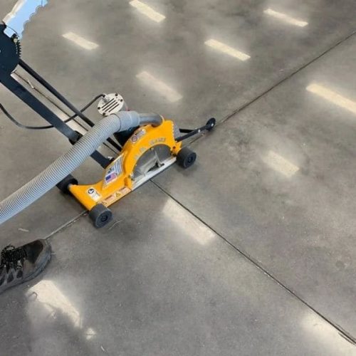 Mark-III Dust Buggy positioned along a concrete floor joint for clean-out work
