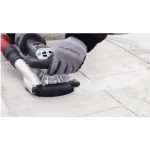 Worker using Metabo RSEV 19-125 RT Renovation Grinder on a wall surface
