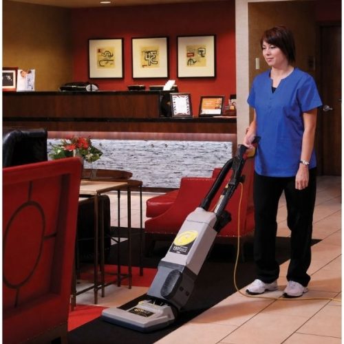 Worker using ProTeam 1500XP Upright Vacuum on a commercial carpeted floor