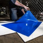 Worker stepping on Surface Shields Clean Mats to remove dust and dirt from footwear