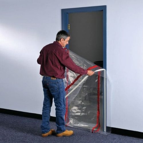 Worker applying ZipDoor Standard Door Kit to a commercial doorway
