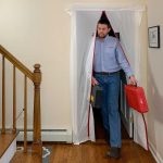 Person using ZipDoor Magnetic Door Kit installed in a residential doorway