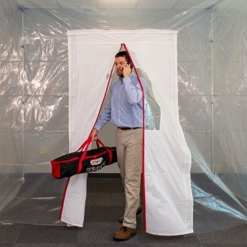 Person passing through ZipDoor Magnetic Door Kit installed in a commercial containment area