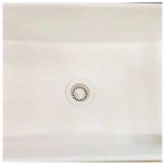Wheat basket strainer installed in a white sink basin