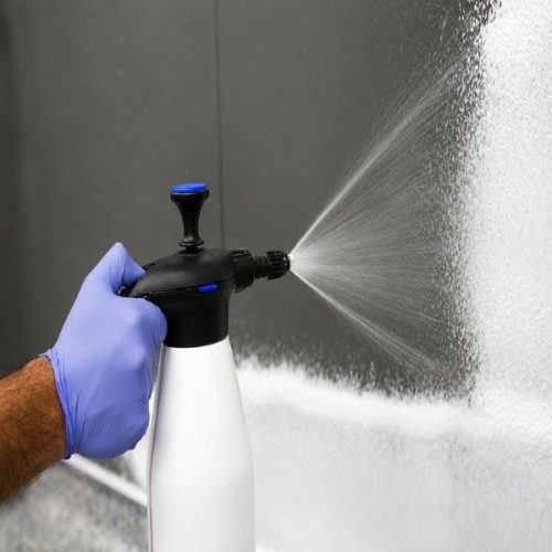 Worker using Foam-It Pump Up Foam Unit to apply cleaning foam on a surface