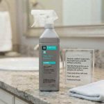 StoneTech Soap Scum Remover for Natural Stone 24 oz Sprayer applied to a stone shower surface