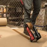 Worker using Surface Shields Builder Board Tape 3" x 180' to seal builder board seams