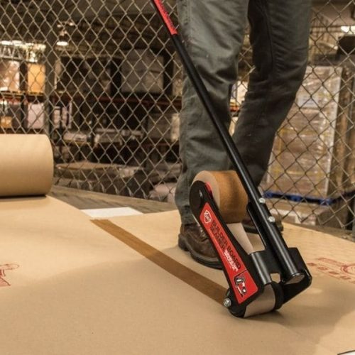 Worker using Surface Shields Builder Board Tape 3" x 180' to seal builder board seams