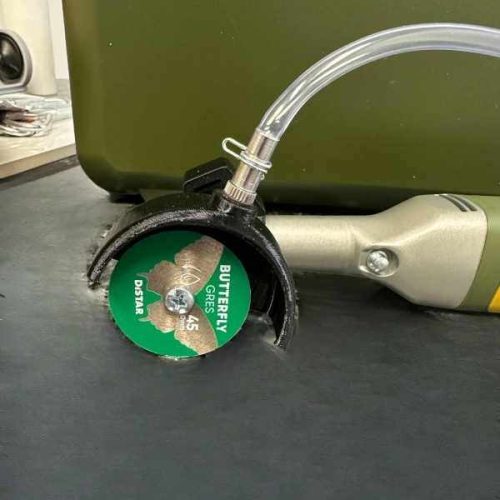 DiStar Water Guard Kit mounted on angle grinder with water hose and diamond blade